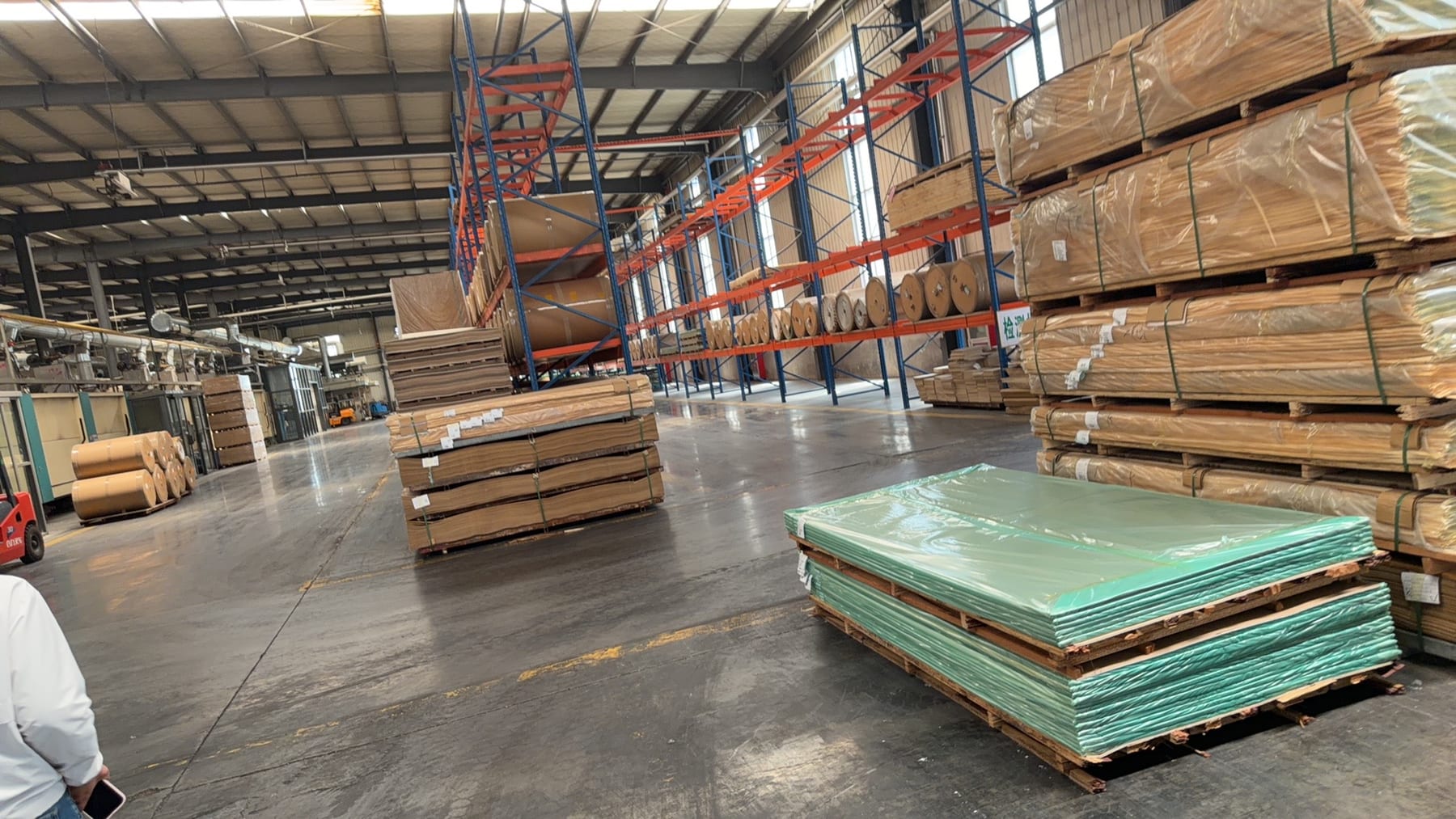 Board warehouse, with stacks waiting for surface film.
